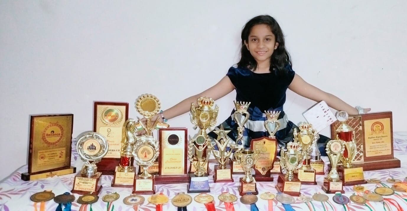 Prisha Shah with chess trophies